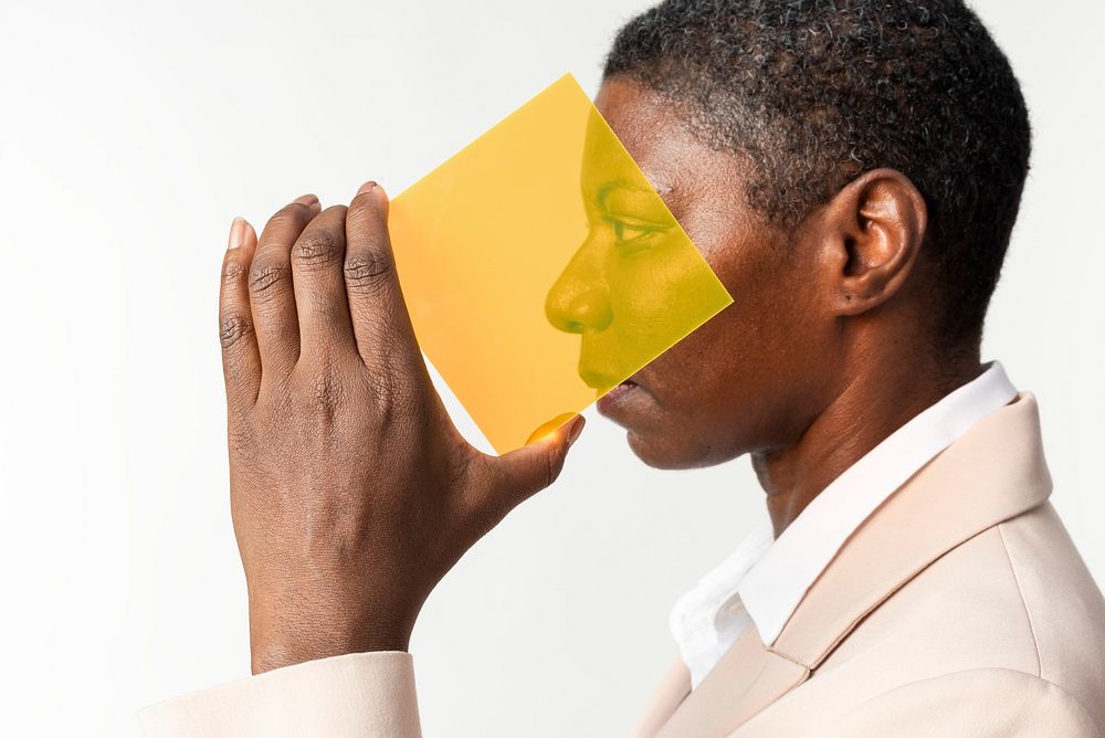 Woman presenting yellow transparent plate futuristic technology