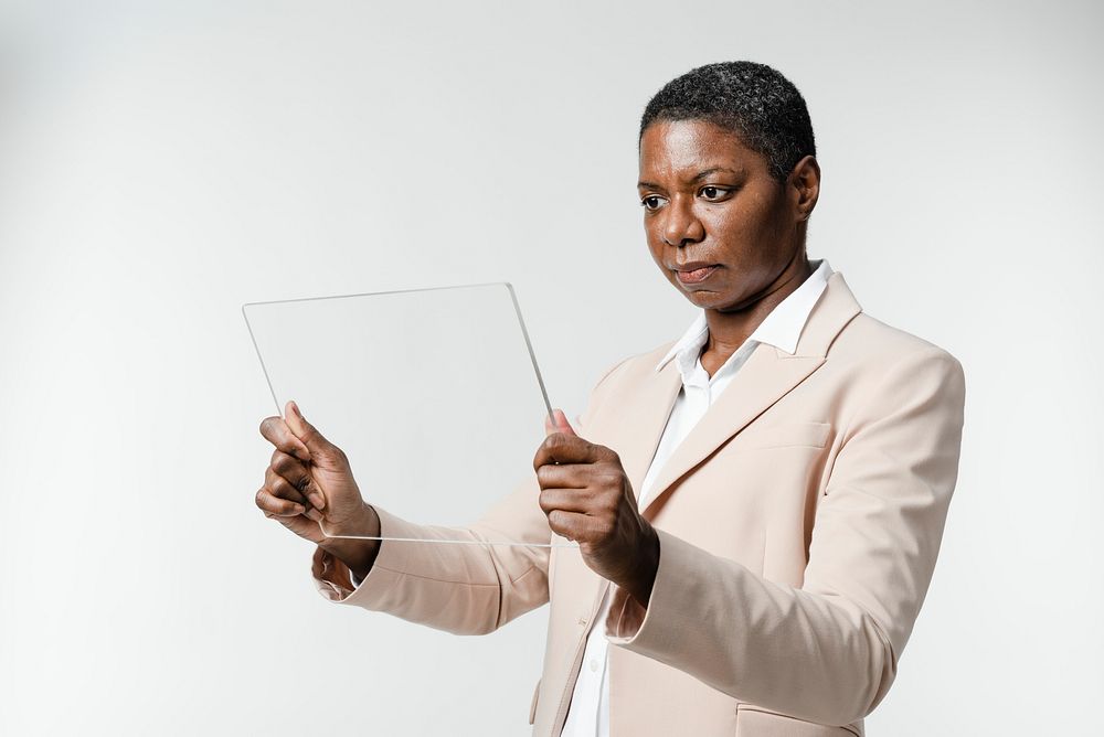 Business woman using transparent tablet