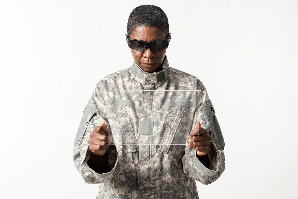 Female soldier using transparent tablet military technology