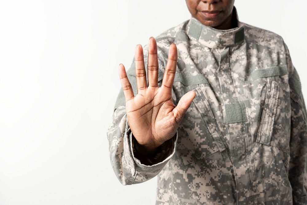 Female soldier with hand gesture