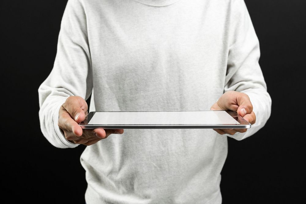 Man holding digital tablet with blank white screen