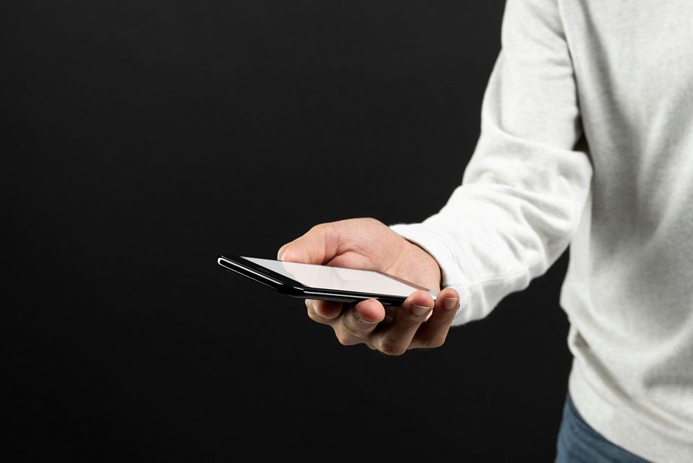Man holding smartphone with a white screen