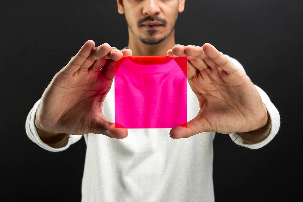 Man presenting pink transparent plate futuristic technology