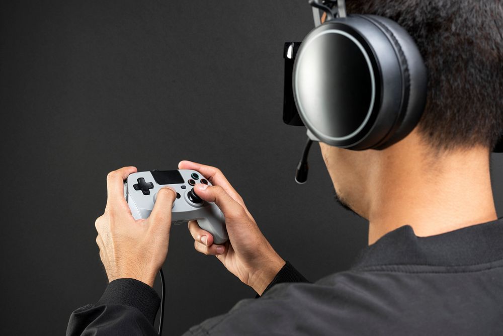 Man wearing a headset and holding a gaming controller