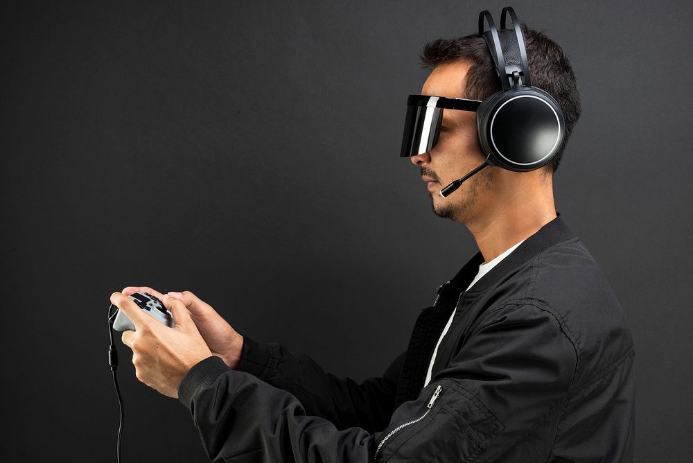 Man wearing a headset and holding a gaming controller