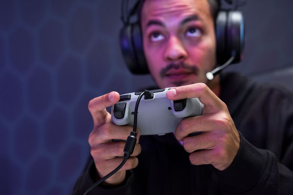 Professional eSport gamer playing a game with gaming controller