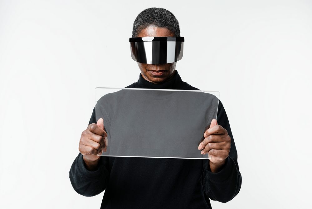 African American woman experiencing VR simulation with transparent tablet
