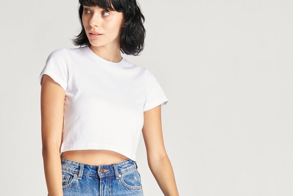 Woman in a white crop top and blue jeans 
