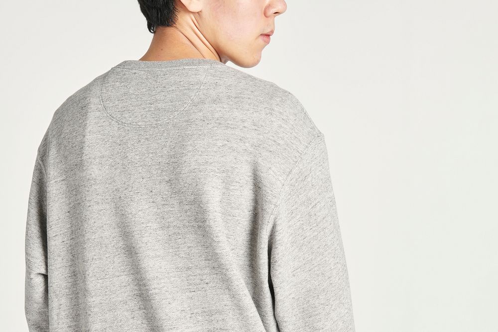 Rear view of an Asian man wearing a gray sweatshirt 