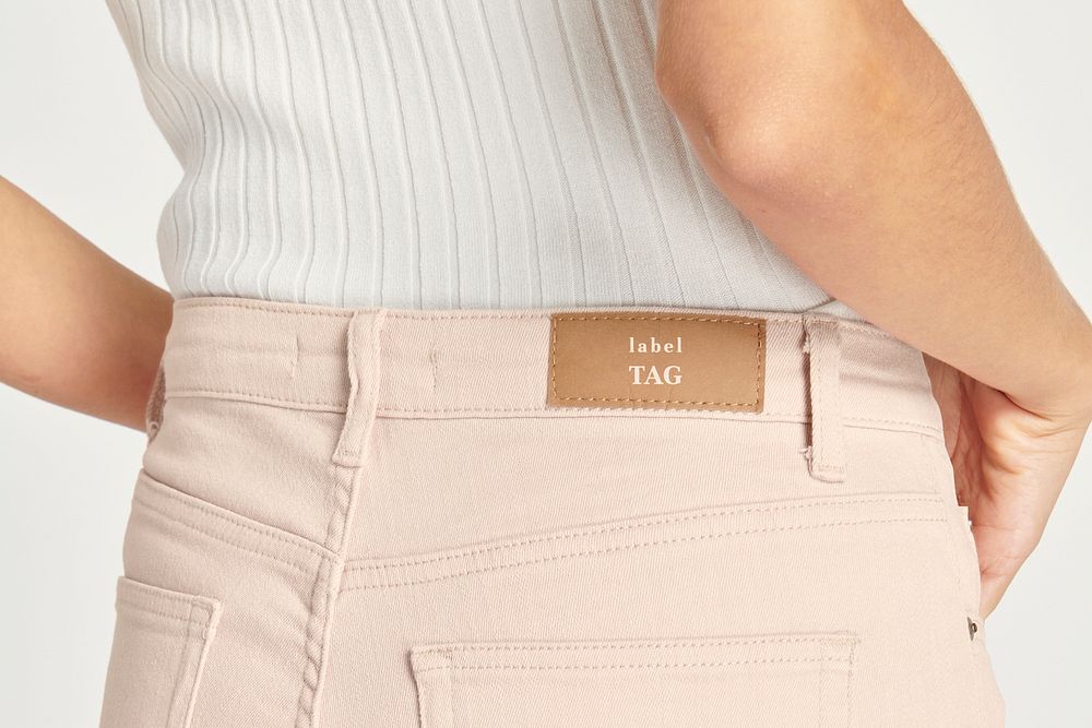 Woman in baby pink shorts with a label mockup 
