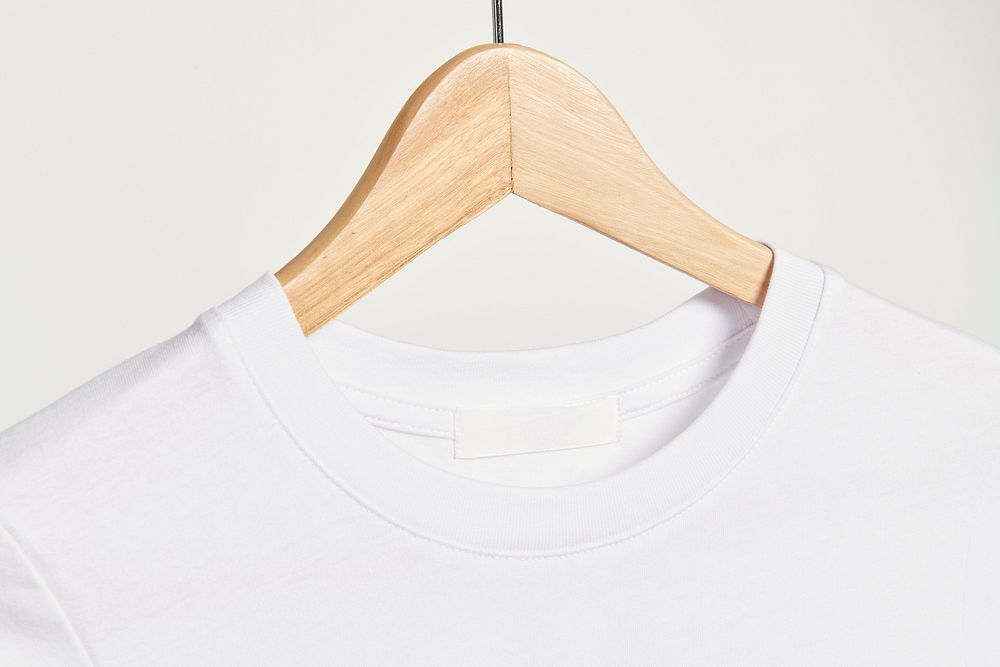 White t-shirt tag mockup on a wooden hanger