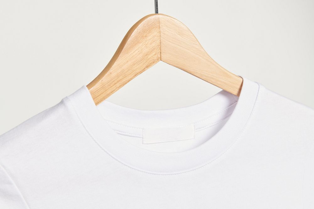 White t-shirt on a wooden hanger
