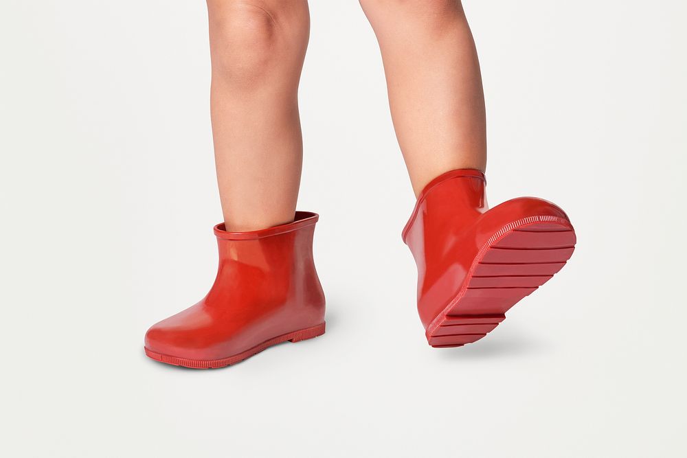 Png kid's feet with red rubber boots psd mockup studio shot