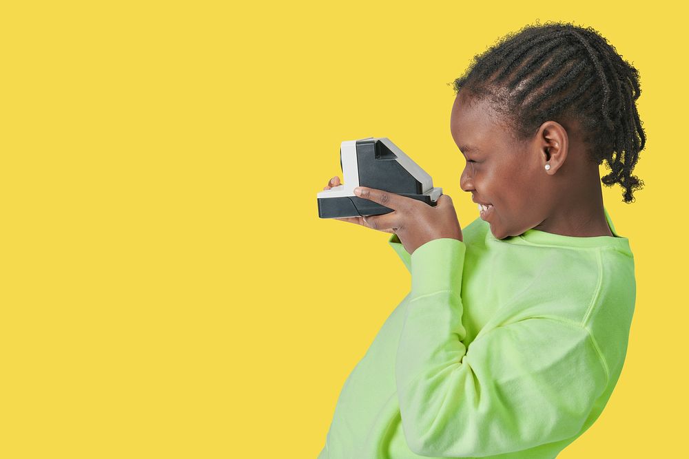 Black kid with instant camera