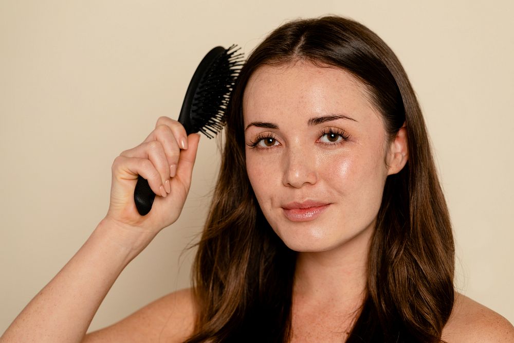 Woman brushing her brown hair