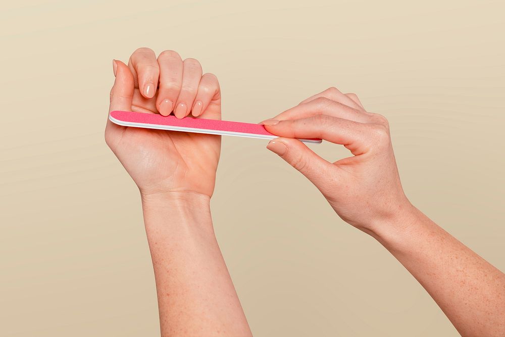 Manicure & nail file on beige background
