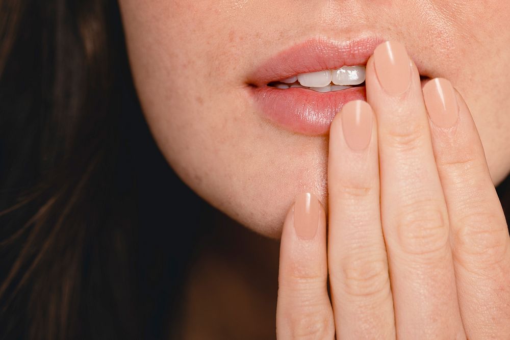 Manicured nails & pink lips on woman