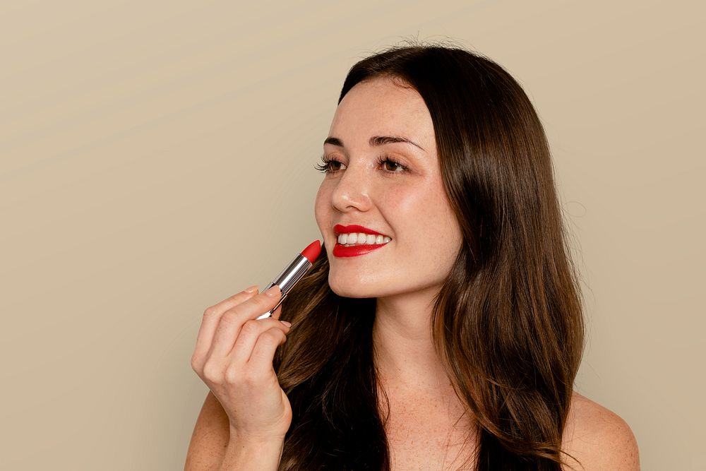 Woman applying red lipstick, cosmetic psd