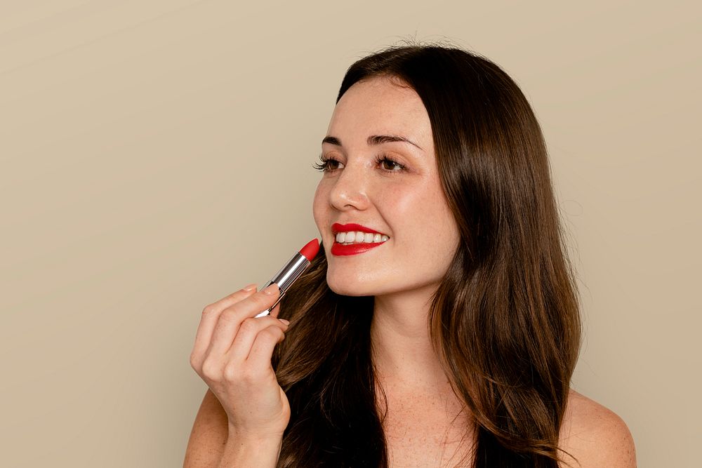 Woman putting on red lipstick, cosmetic & beauty