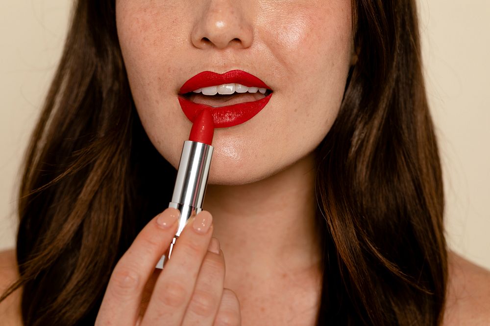 Woman putting on red lipstick, cosmetic & beauty