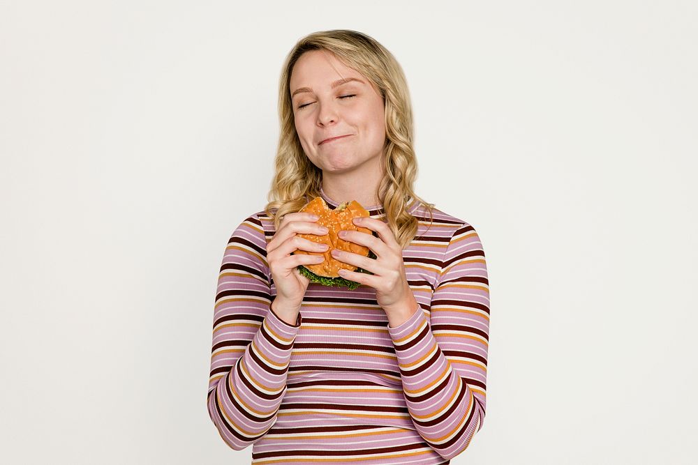 Woman eating burger, junk food psd