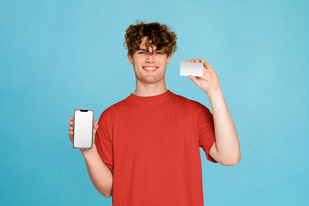 Man holding phone and card, isolated on blue background