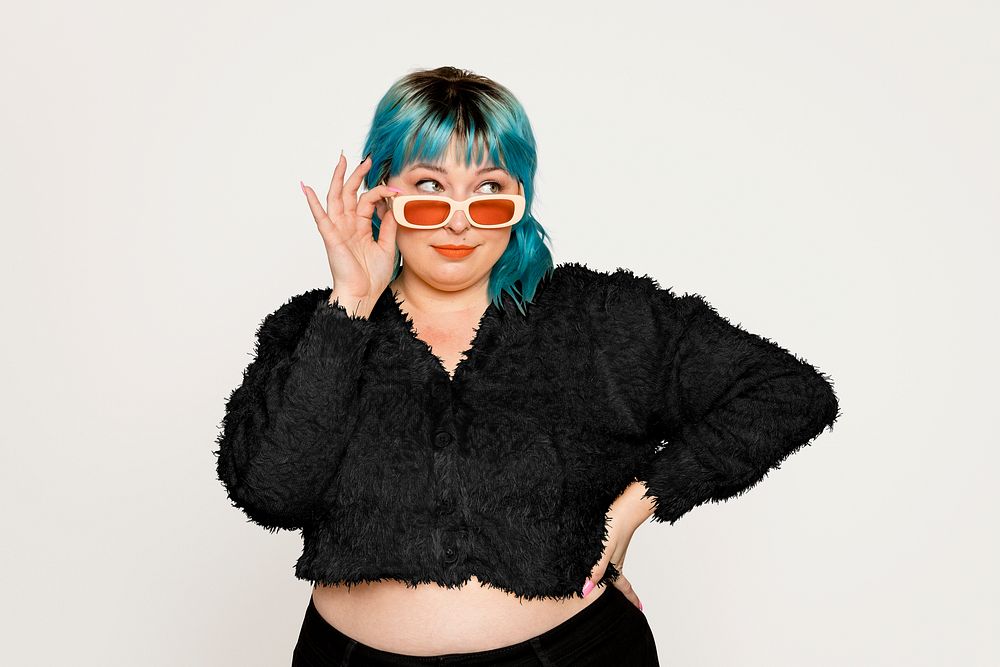 Curvy woman with sunglasses on off white background
