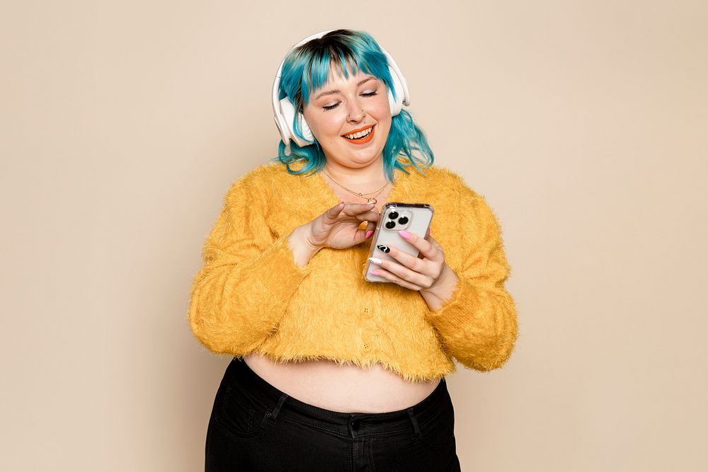 Woman listening to music, beige background