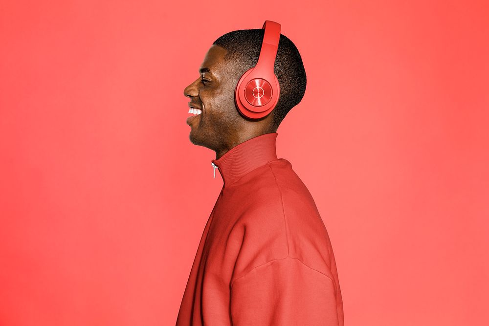 Man listening to music, red background