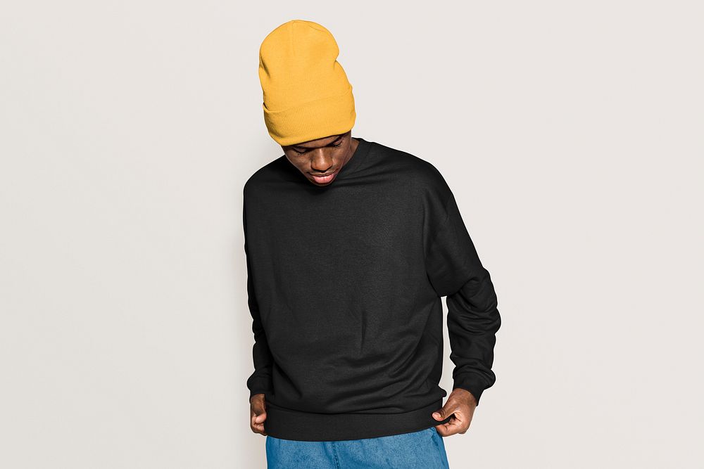 Trendy man in black college sweater and beanie 