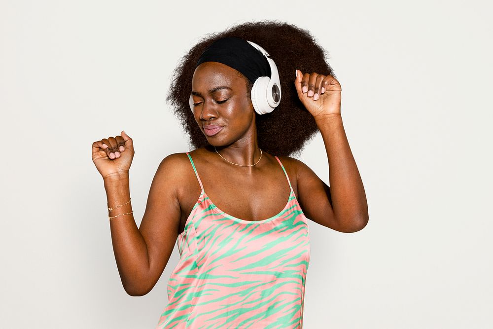 African American woman dancing and listening to music psd
