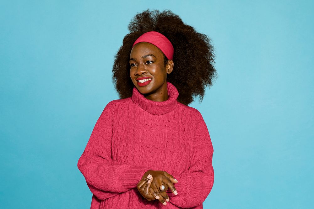 Woman in pink sweater, isolated on blue background
