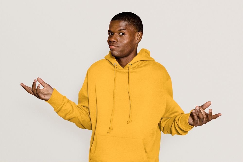 Shrugging African American man in yellow hoodie