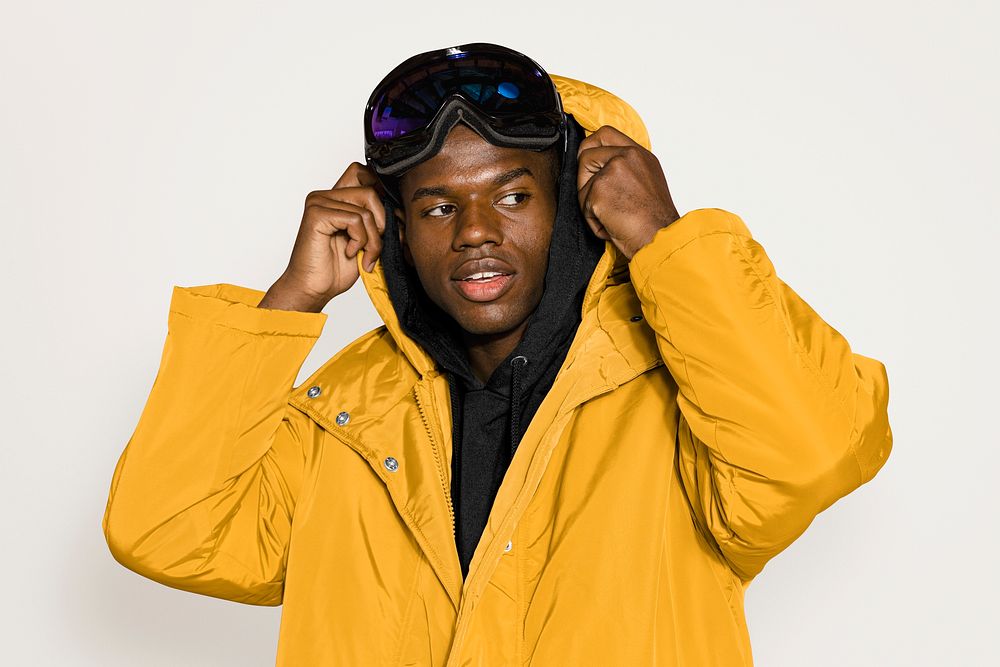 Man in ski goggles and yellow jacket