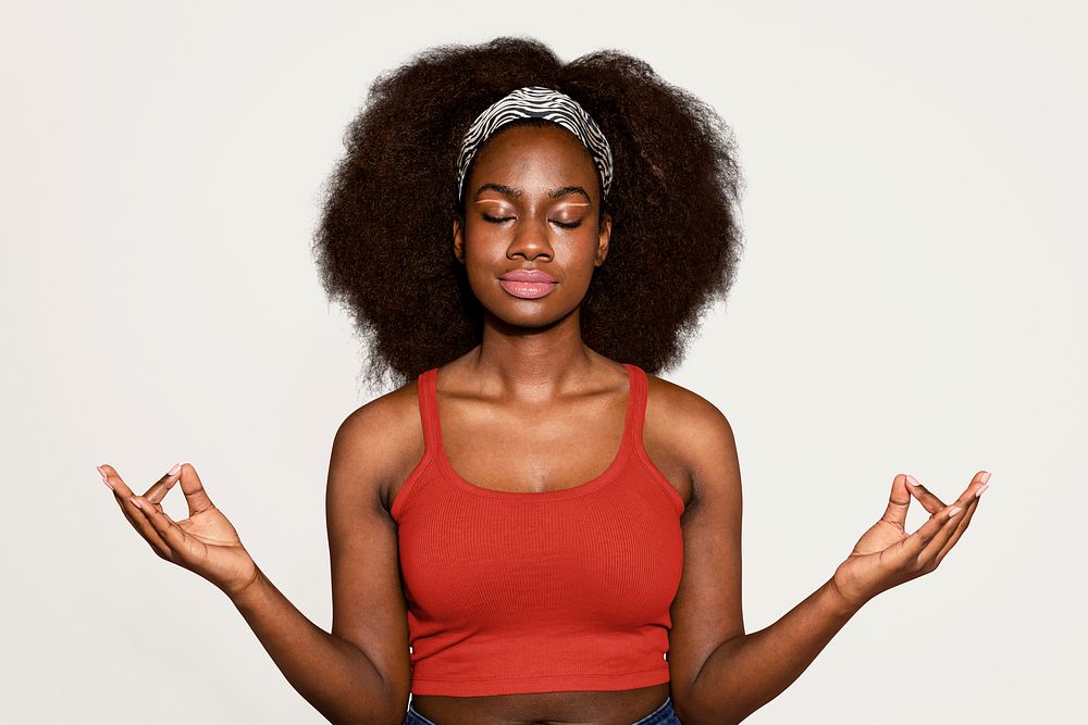 Black yoga woman meditating, off white background