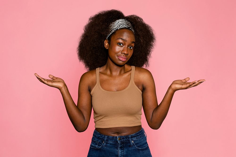 Confused woman on pink background