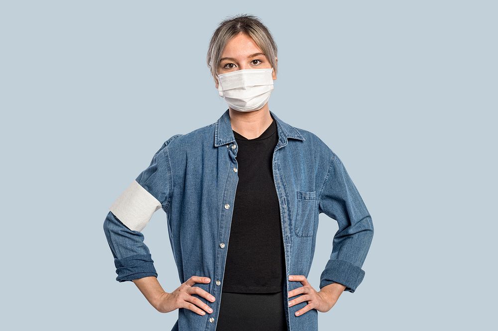 Female volunteer wearing a face mask and armband portrait