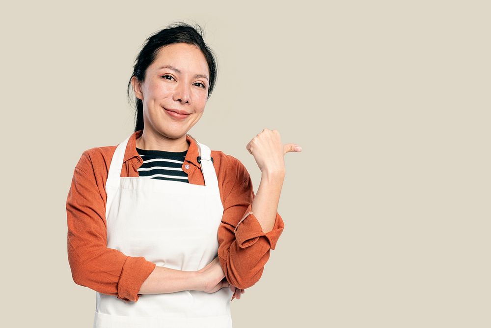 Cheerful Asian woman in an apron