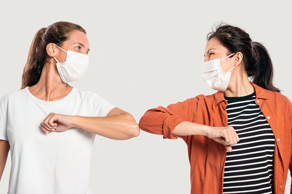 Women mockup psd with face masks doing elbow bumps new normal greeting