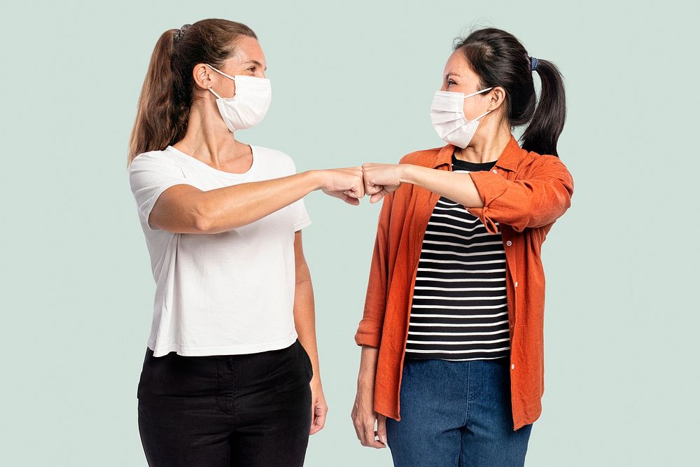 Women mockup psd with face masks doing elbow bumps new normal greeting