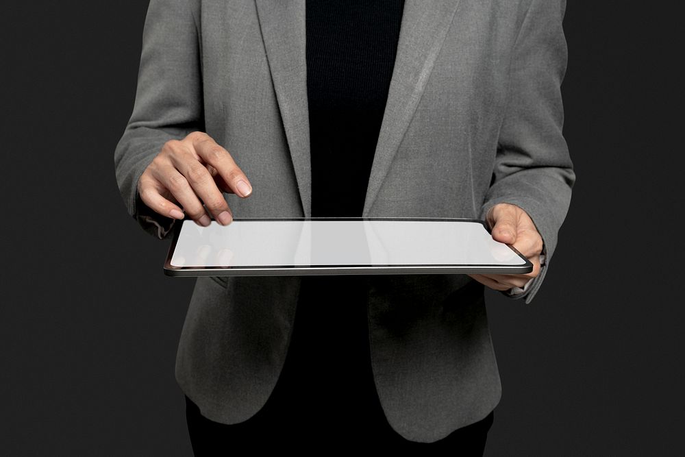 Businesswoman presenting invisible hologram projecting from tablet advanced technology