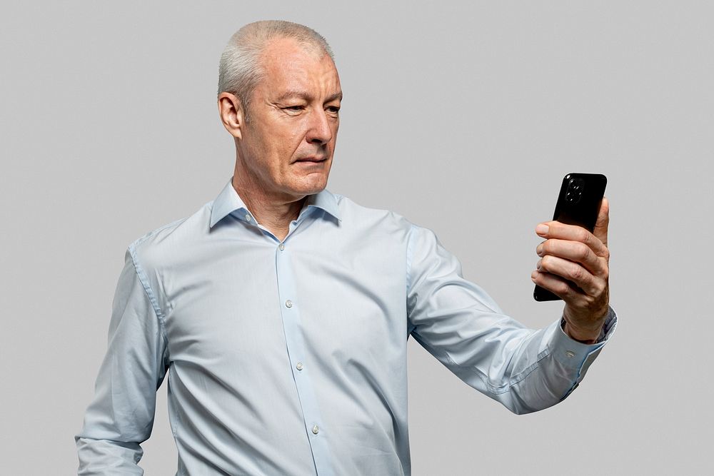 Businessman scanning his face to unlock phone security technology