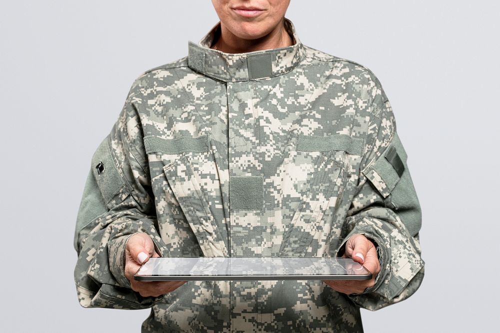 Female soldier mockup psd holding a tablet army technology