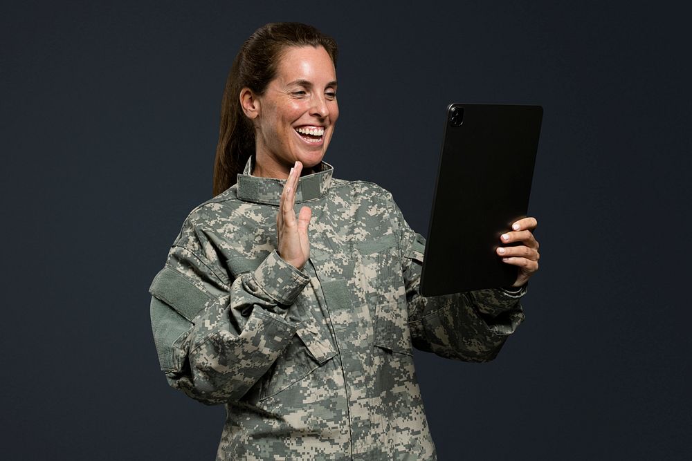 Female soldier mockup psd using a tablet army technology