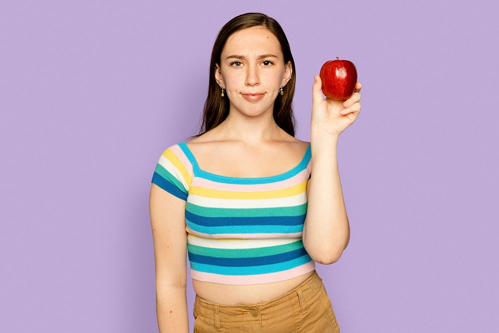 Woman holding apple mockup psd for healthy eating campaign