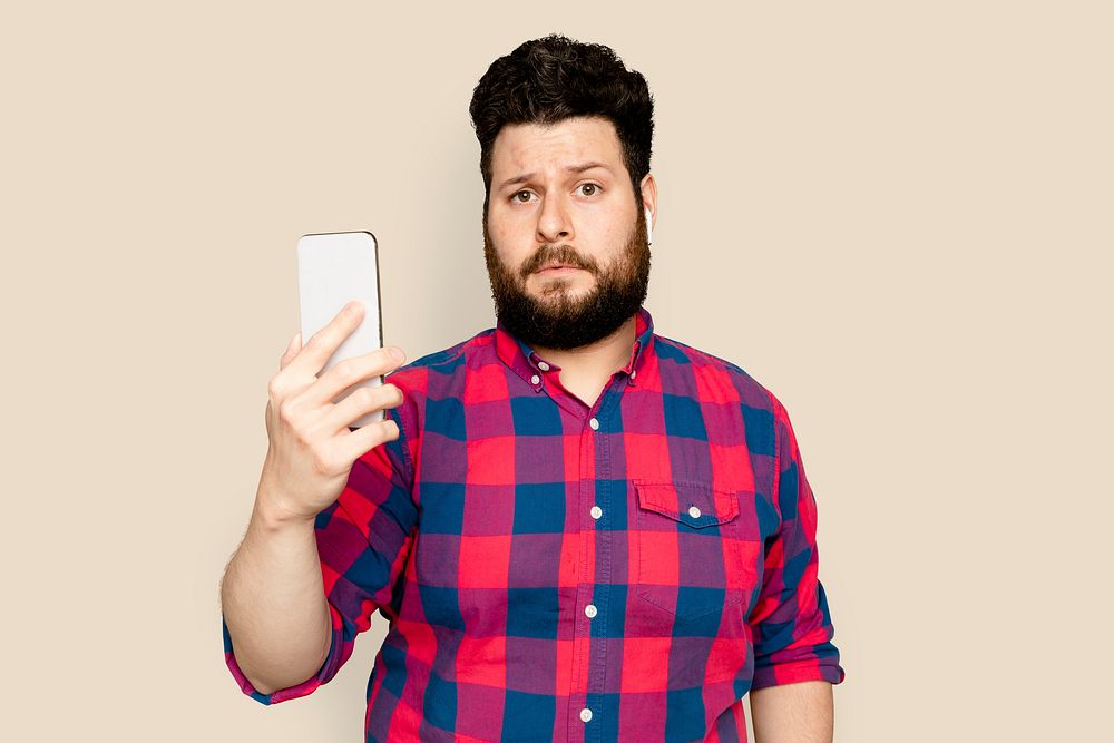 Bearded man streaming music with smartphone digital device