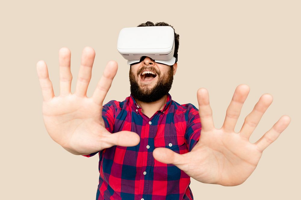 Bearded man having fun with VR headset digital device