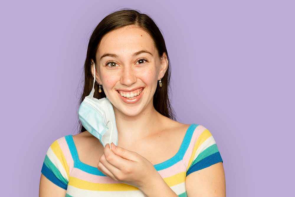 Woman taking off mask in the new normal