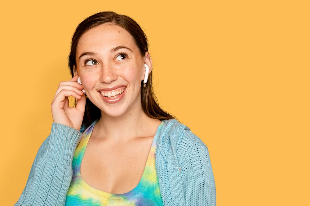 Cheerful woman mockup psd listening to music through earphones