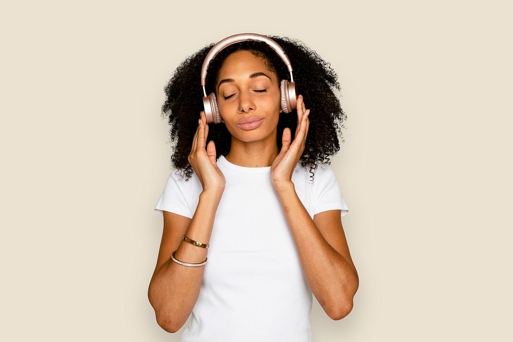 Beautiful woman mockup psd listening to music through headphones digital device
